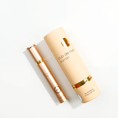 Armaf Club De Nuit Woman 10ml EDP — Rose gold spray bottle and cylindrical box on a white background