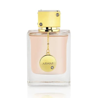 Armaf Club De Nuit Woman — Clear glass perfume bottle with pink liquid, gold cap, and circular gold charm with 'ARMAF' text